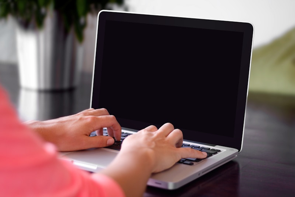 Hands on a laptop keyboard