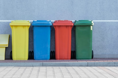 An array of colorful trash cans